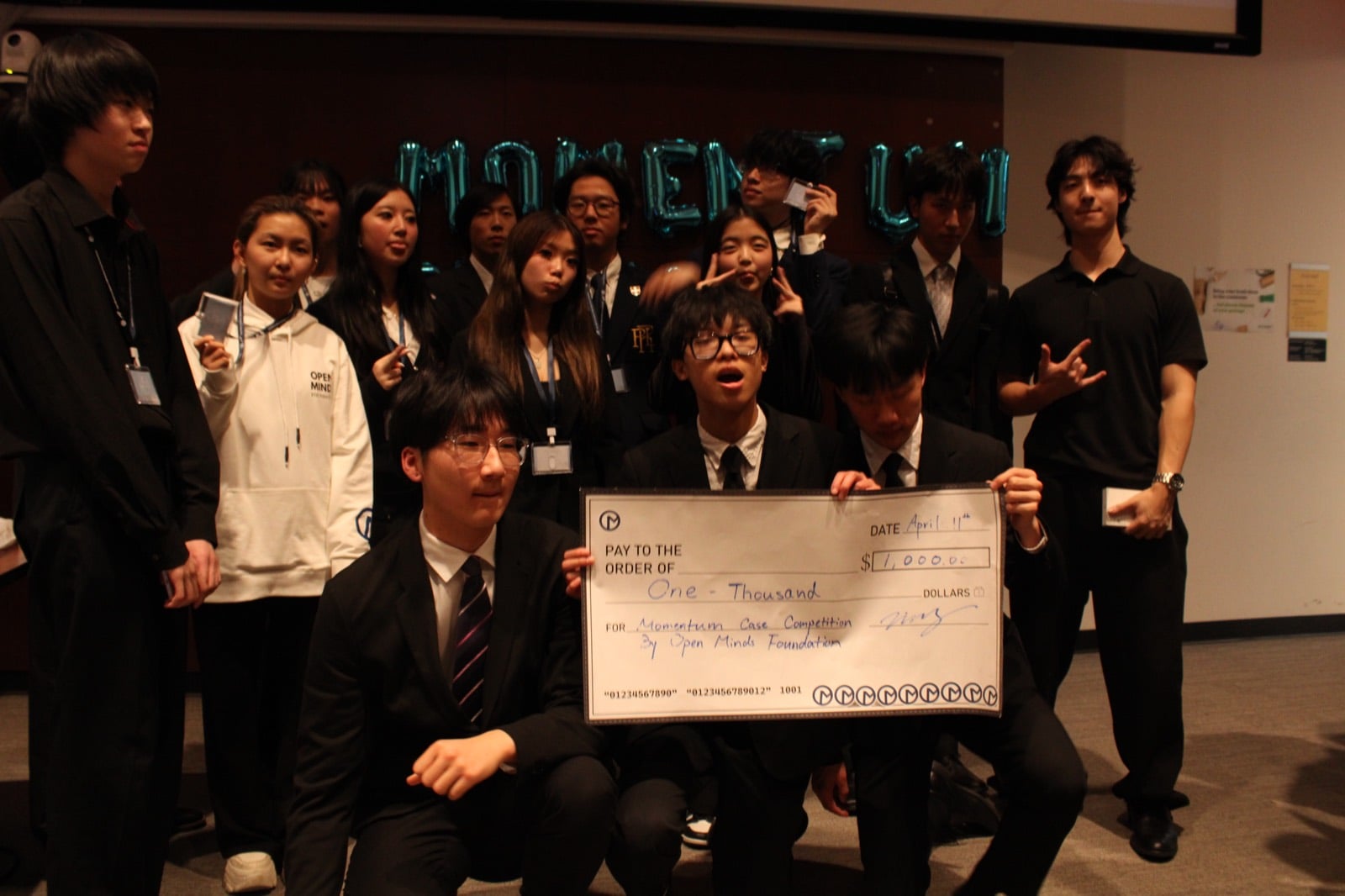 Momentum participants celebrating with a prize cheque